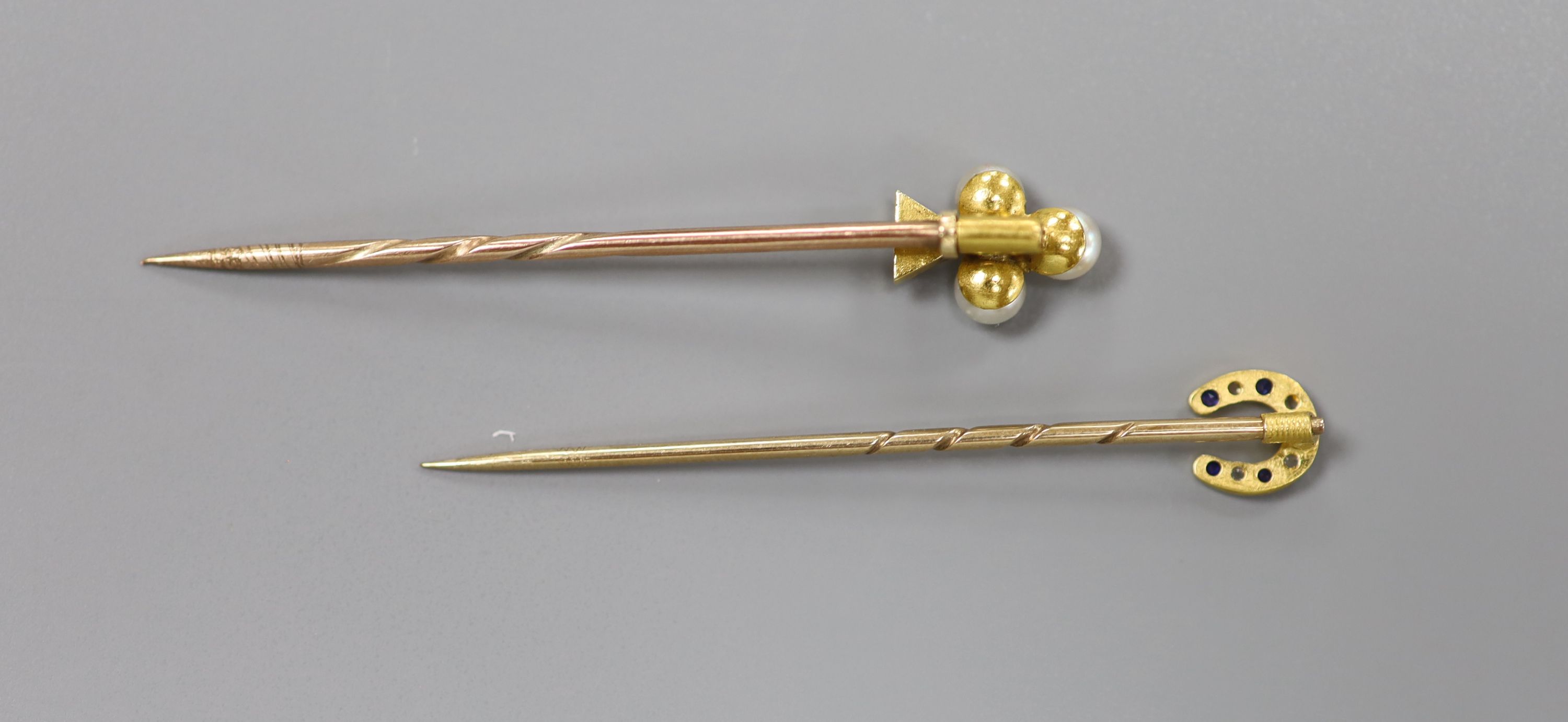 Three assorted early 20th century yellow metal and gem set stick pins